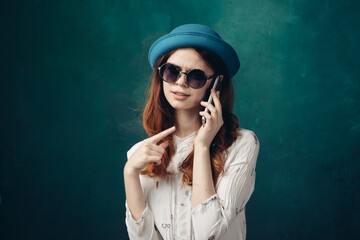 fashionable woman in blue hat with phone in hands communication technology