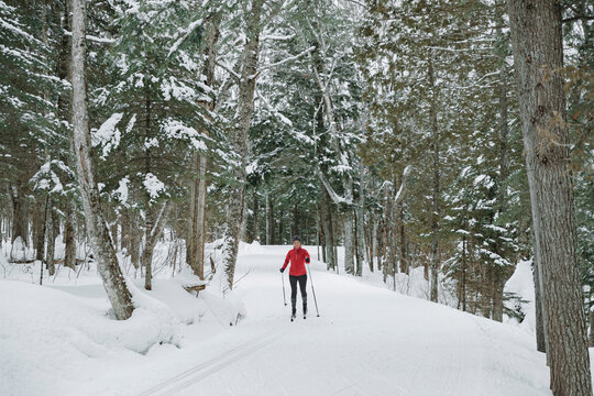 Cross Country Skiing Classic Style Nordic Skiing In Forest. Woman In Winter Doing Fun Winter Sport Activity In The Snow On Cross Country Ski In Beautiful Nature Landscape