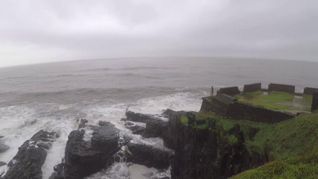 Devil's eye goa in monsoon. It is also known as devil's finger near Sinquerim Fort to Lower Aguada. Water waves crash into rocks and Sea foam creating amazing shapes and patterns