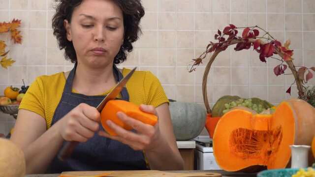 Thanksgiving Holiday Tradition. Happy mother and daughter cook pumpkin pie in the kitchen. Autumn home decoration