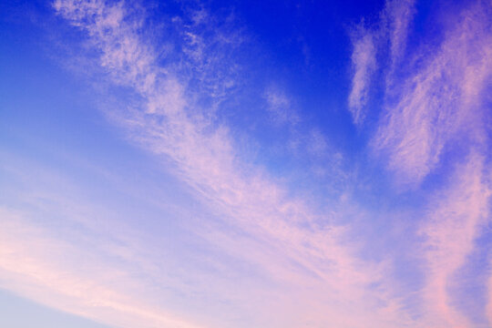 Pink сirrus clouds on blue sky background closeup, dawn cirrostratus cloud texture, evening sunset or morning sunrise clouds, fluffy wispy cloudy skies, cloudscape, beautiful heaven view, cloudiness
