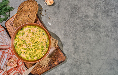 Hot chowder with vegetables and mushrooms, top view. Soup with sour cream and dill. Served with black bread and garlic. A healthy fall lunch. Copy space for menu