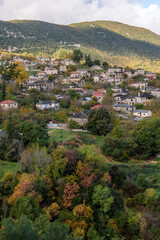 Fototapeta premium Panorama view of village Aristi with Picuresque stone buildings during fall season in Zagori Greece.