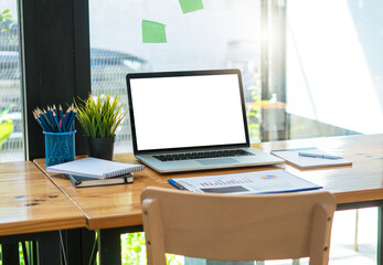 Front view of mock up laptop on table in office and background in the coffee shop.