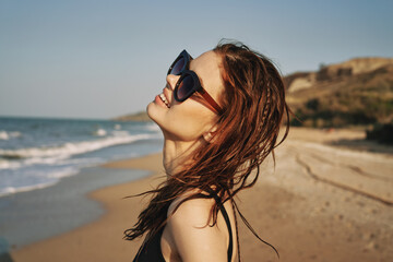 Fototapeta na wymiar cheerful woman sunglasses posing black swimsuit island