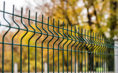 grating wire industrial fence in autumn