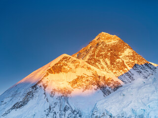 peaks Everest and Nuptse in last sun lights under blue sky with copy space in giant resolution