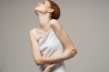 Obraz premium disgruntled woman rheumatism elbow pain health problems light background