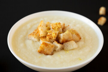 Homemade Cauliflower Soup with Croutons and Oil, side view. Close-up.