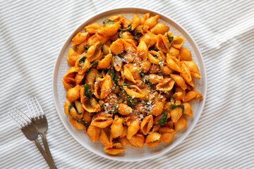 Homemade Pumpkin Pasta with Walnuts and Spinach, top view. Flat lay, overhead, from above.