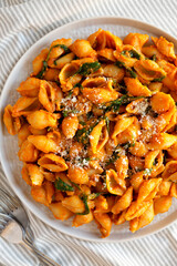 Homemade Pumpkin Pasta with Walnuts and Spinach, top view. Flat lay, overhead, from above.