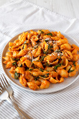 Homemade Pumpkin Pasta with Walnuts and Spinach, side view.