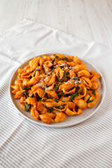 Homemade Pumpkin Pasta with Walnuts and Spinach, low angle view.