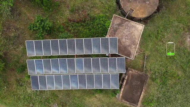 Alternative energy  wind mill and solar panel green energy production. Solar panel produces green, environmentally friendly energy from sun. Landscape solar plant that is located inside a valley