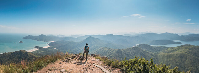 Amazing panorama of Man standing of Sharp Peak, Sai Kung, Hong Kong.