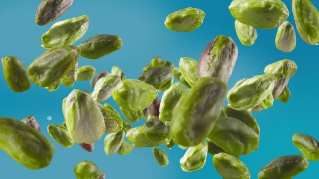 Flying of Peeled Pistachios in Sky Blue Background