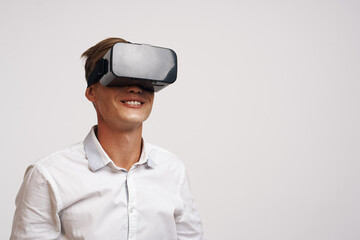 Man in a white shirt vr glasses gadget device video light background