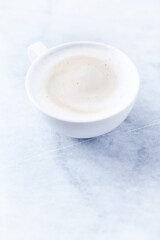 Coffee with milk on bright stone background. Close up. Copy space. 	