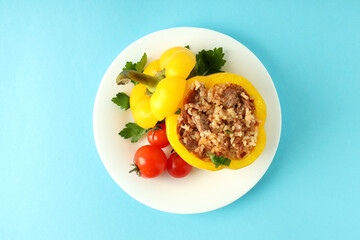 Stuffed pepper in plate on blue background,top view