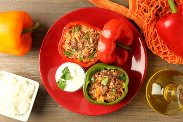 Concept of tasty food with ​stuffed pepper on wooden background