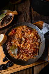 Polish bigos cooked according to an old recipe with wine and plum