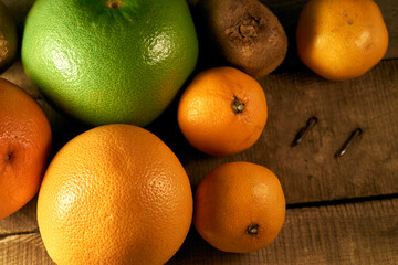 Multiple citrus fruits on a wooden background