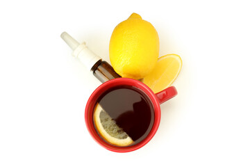 Nasal spray, lemon and cup of tea isolated on white background