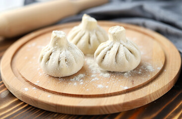 Georgian dumplings or khinkali. Cooked Georgian homemade khinkali on a cutting board in flour. Selective focus