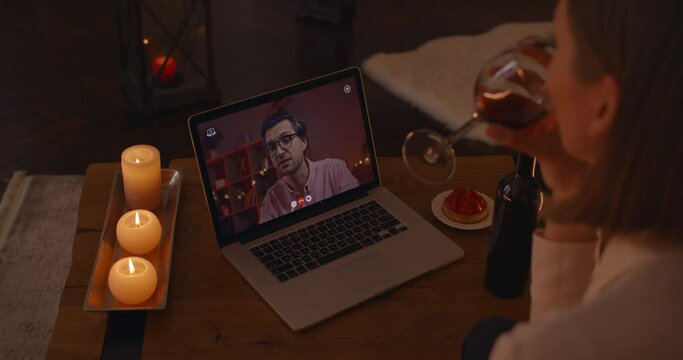 Woman having date with boyfriend via video call on laptop