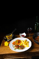 Homemade meatballs with french fries and vegetables