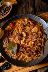 Polish bigos cooked according to an old recipe with wine and plum