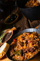 Polish bigos cooked according to an old recipe with wine and plum