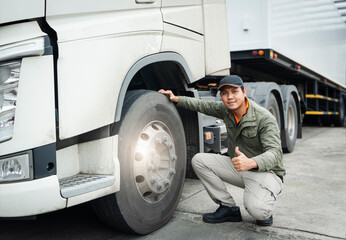 Asian Truck Driver Giving Thumb-Up and Checking Semi Truck Wheels Tires. Truck Inspection Maintenance and Safety Driving.	