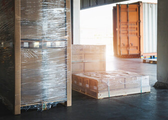 Package Boxes Wrapped Plastic Flim on Pallets Loading with Shipping Cargo Container. Truck Parked Loading at Dock Warehouse. Delivery. Warehouse Logistics. Freight Truck Transportation.	