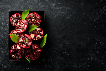 Fresh pomegranate fruits on a metal tray. Top view. Free space for your text.