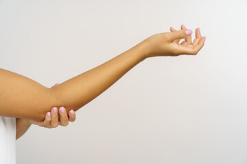 Woman with injured arm touching elbow. Closeup of african american female holding painful hand...