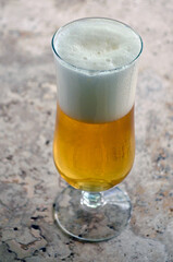 A glass of kolsch beer on the table