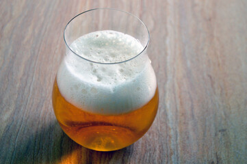 A glass of golden ale on the table