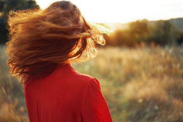 woman in red dress in the field walk freedom landscape © VICHIZH