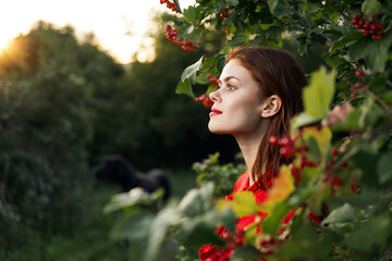woman in red dress green leaves nature freedom summer © VICHIZH