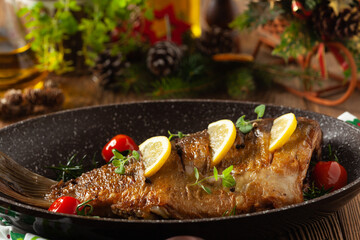 Fried carp whole. Served with lemon and cherry tomatoes.