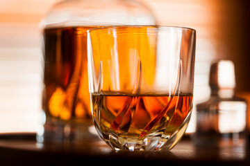 Whiskey glass close up in a dark bar setting. Selective focus on the glass. Copy space.High quality photo