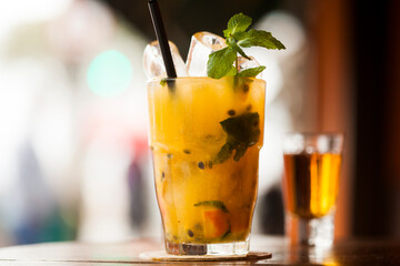 Brazilian caipirinha drink, fruits with Brazilian cachaça on the beach with blue sky