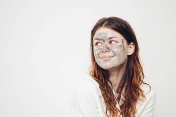 cheerful woman in bathrobe face cream skin care