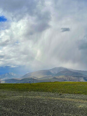 Rain cloud and rain coming from it in the Altai mountains