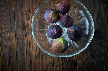 Organic figs over white rustic wooden background