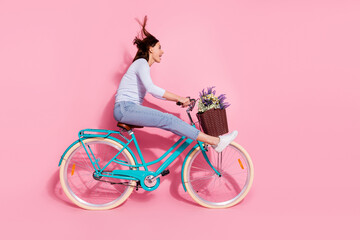 Photo of excited funky young lady dressed white jumper enjoying riding bicycle looking empty space...