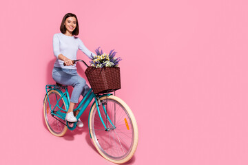 Photo of funky shiny young lady dressed white jumper enjoying riding bicycle empty space isolated...