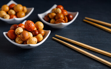 Senbei japanese snack. Senbei traditional Japanese snack in a bowl close-up. Rice crackers with nori, peanuts with sesame seeds, and other snacks. Mix traditional Japanese snack food