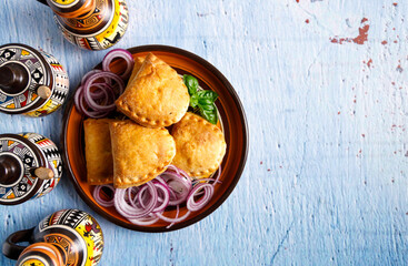 Homemade empanadas with sauces. South American street food. These delicious beef empanadas are mandatory to eat, they have a crunchy dough and an exquisite ground beef filling.